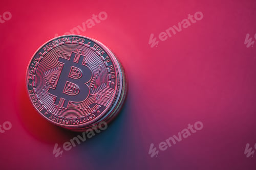 Preview: Stack of crypto coins on red, pink background with neon illumination.