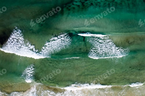 Preview: Beach, beautiful waves, blue water at sunrise. Top view from drone.
