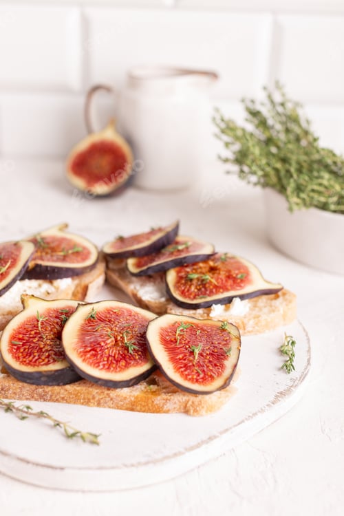 Preview: Sweet bruschetta with figs on a white board