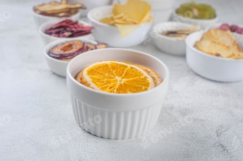 Preview: assorted ripe fruits and dried chips on grey background.