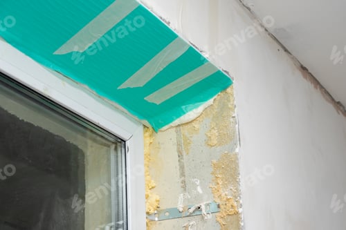 Preview: Fragment of a window with a plastic slope made of insulated panels covered with a protective film