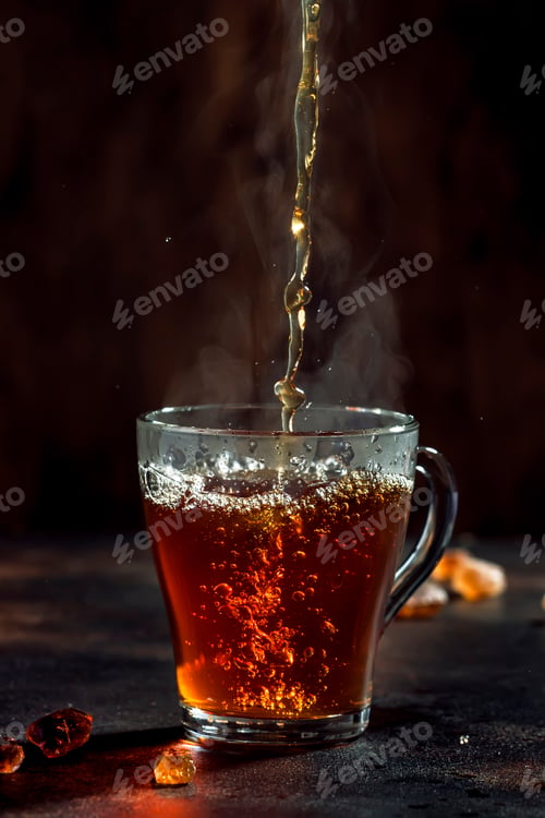Preview: Black tea pouring into glass cup with natural steam