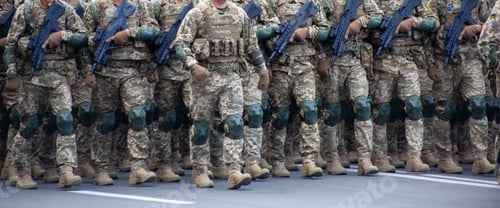 Preview: Military soldiers march in a parade with weapons. Pixel uniform. Soldier's legs. Military background