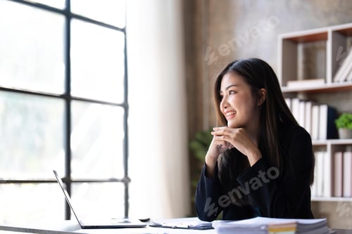 Preview: Young beautiful businesswoman working on laptop and There are documents on the table at bright
