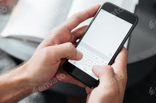 Preview: Cropped photo of young man chatting by phone.