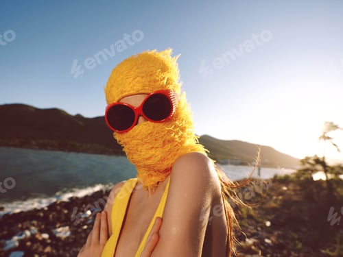 Preview: Woman, yellow hat, sunglasses, ocean, mountains a stylish woman in a yellow hat and sunglasses