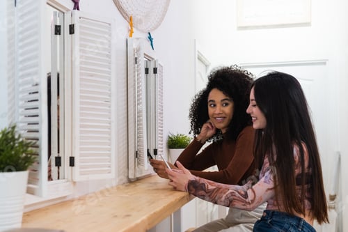 Preview: Happy multiracial women chilling together in bar