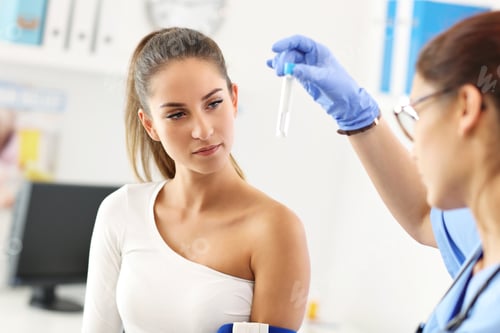 Preview: Adult woman having blood collection visit at female doctor's office