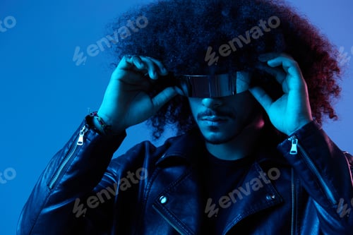 Preview: Portrait of fashion man with curly hair with stylish glasses on blue background multinational