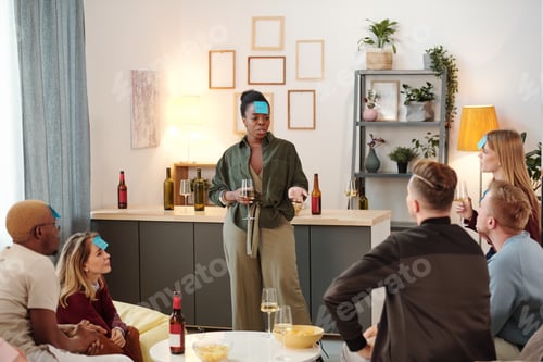 Preview: Group of young intercultural friends listening to African guy singing at party