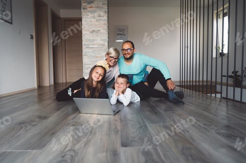 Preview: Little boy laying on the floor while whole family talking to grandparents over video call