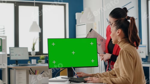 Preview: Colleagues working with green screen on display
