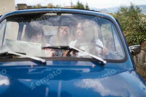 Preview: Friends reading route map inside car