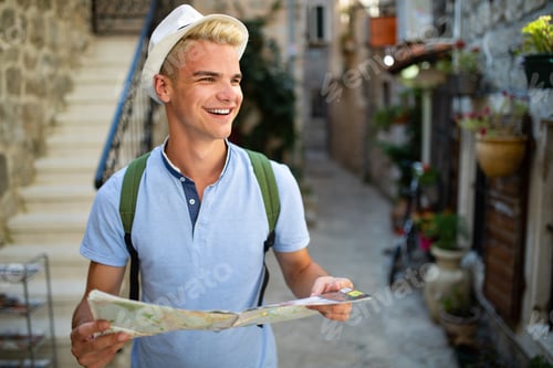 Preview: Happy young tourist man having fun and travelling on summer vacation
