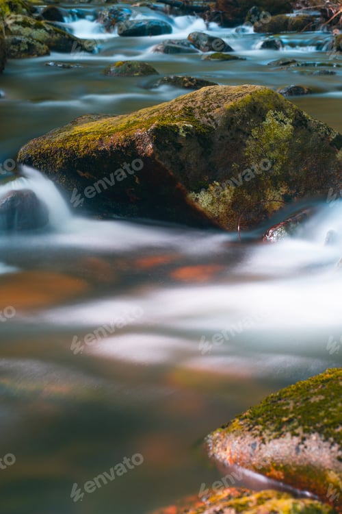 Preview: Vertical shot of a beautiful river with many rocks in Dublin, Republic of Ireland