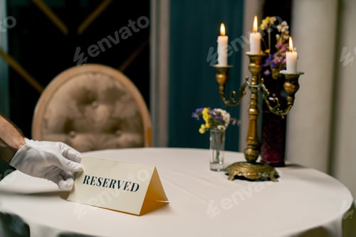 Preview: Close-up of a reservation sign reserved standing on a table in expensive luxury Italian restaurant