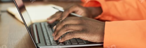 Preview: Black Man Typing on Laptop Computer While Studying in Prison