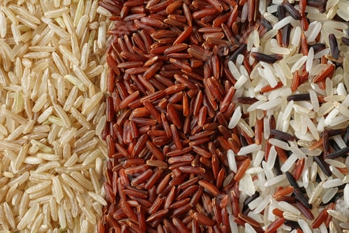 Preview: Brown and other types of rice as background, closeup
