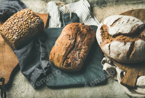 Preview: Various bread loaves on grey concrete background