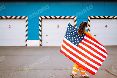 Preview: African woman with face mask posing with american flag.concept of preventing spread of epidemic.