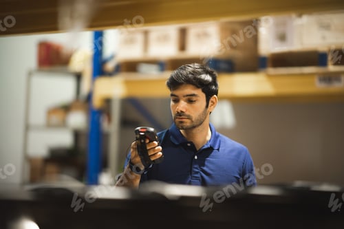 Preview: Worker with scanner making review of goods in warehouse storage, logistic industry concept