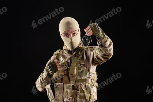 Preview: front view young soldier in uniform with grenade on black background warrior israel