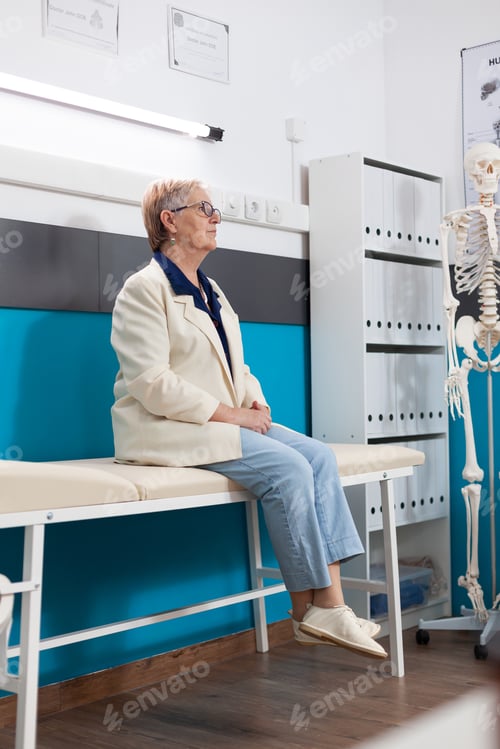 Preview: Retired senior old woman patient standing on bed waiting for healthcare treatment