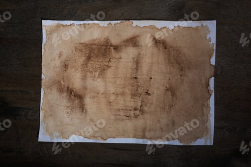 Preview: A Sheet Of Paper With The Effect Of Aging On Dark Wooden Background.