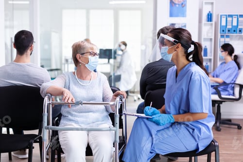 Preview: Handicapped woman discussing with medical staff