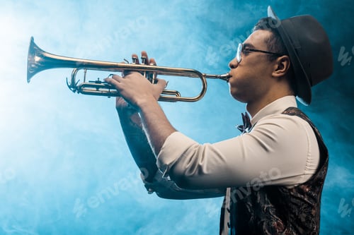 Preview: side view of jazzman playing on trumpet on stage with dramatic lighting and smoke