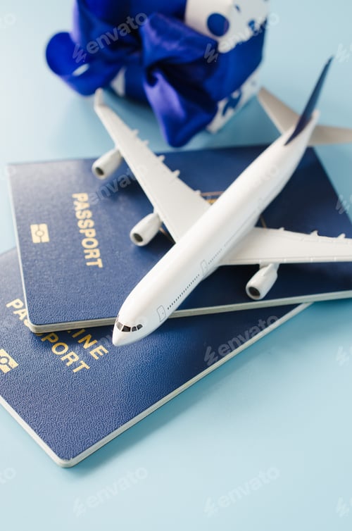 Preview: Traveling as gift. Toy airplane with passports and gift box.