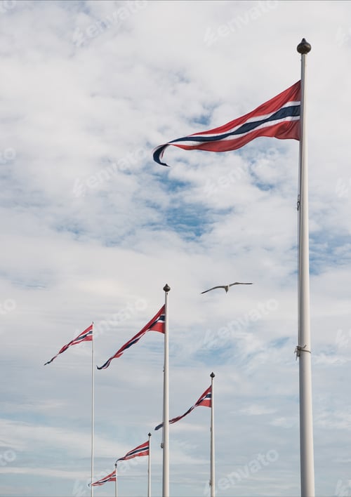 Preview: low angle view of norwegian flags against cloudy sky, Hamar, Hedmark, Norway