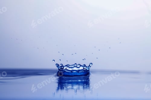 Preview: Splash of clear water with drops on light background, closeup