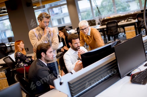 Preview: Senior businesswoman and young business people work in a modern office