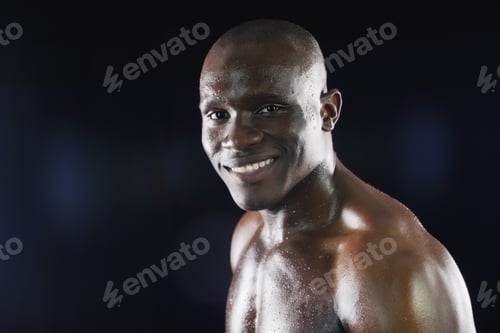 Preview: Studio shot of a young sportsman posing against a dark background