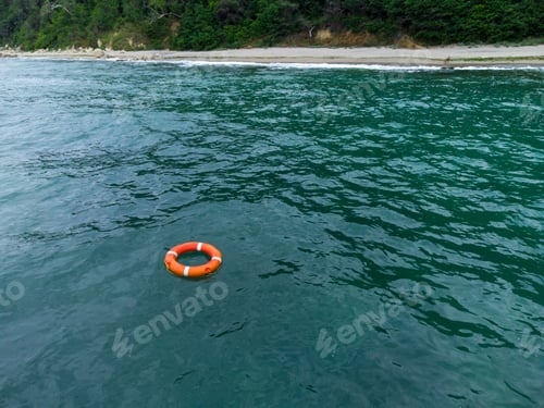 Preview: Top view of lifebuoy in the sea. Life ring floating in a sea.
