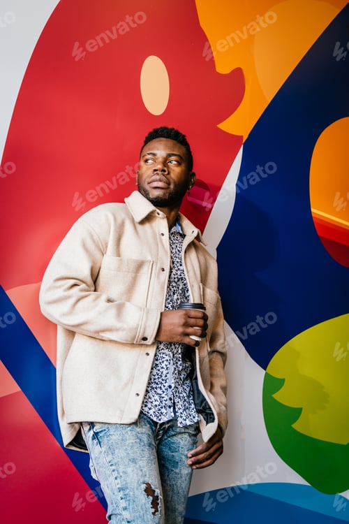 Preview: Confident young black male millennial on a beige coat