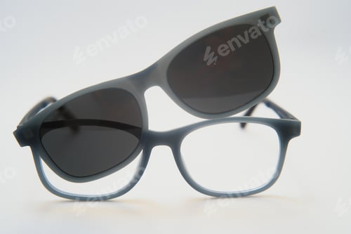 Preview: Stylish sunglasses shot using pink and blue abstract colored lighting with copy space.