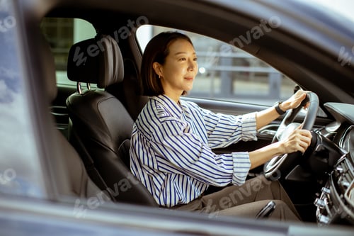 Preview: Korean woman enjoys a sunny drive in stylish city car on a busy day