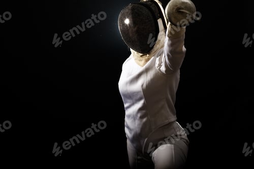 Preview: Portrait of woman wearing white fencing costume practicing with the sword.