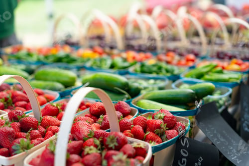 Preview: Strawberries for sale on vegetables market. Raw juicy strawberry in wooden basket standing on market