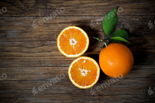 Preview: Fresh oranges sliced on old wooden table
