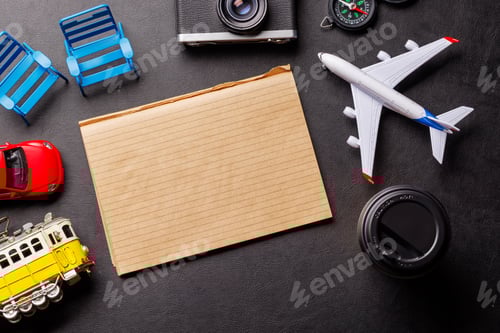 Preview: Creative flat lay of a travel-themed desk with notepad for plans