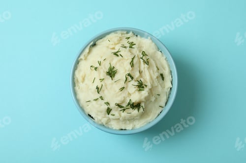 Preview: Plate of mashed potatoes on blue background