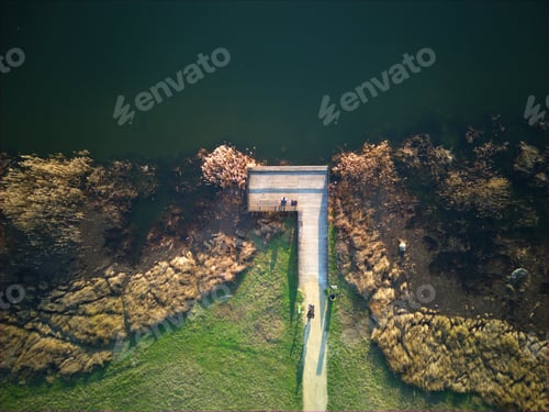 Preview: Idyllic scene of a path alongside a tranquil body of water