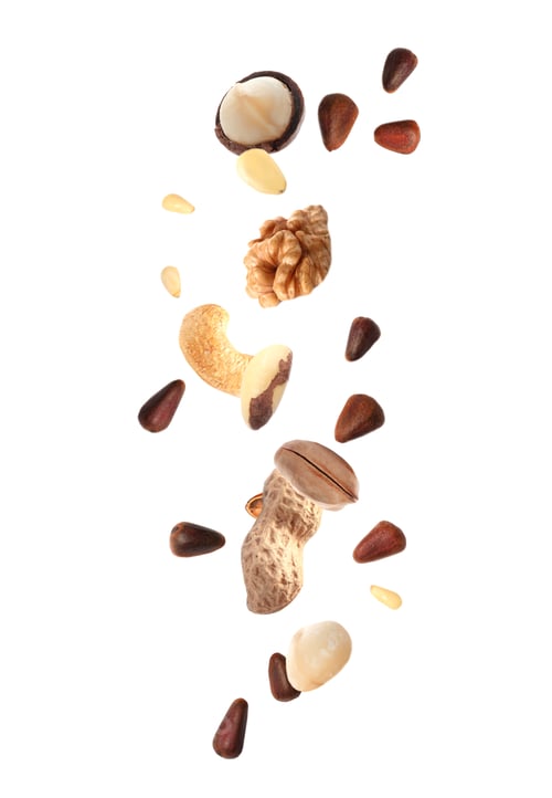 Preview: Different nuts falling on white background