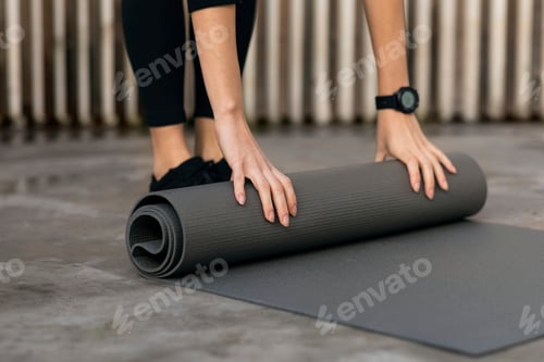 Preview: Preparing for Wellness: Woman Rolling up Yoga Mat