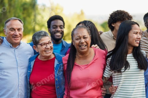 Preview: Crowd of multi generational people hugging each other in front of camera at city park