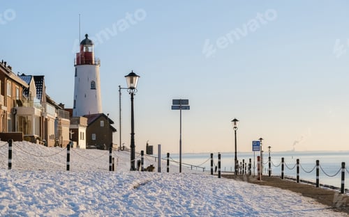 Preview: Lighthouse of Urk during winter with snow in the Netherlands on a cold day in winter