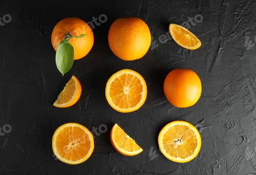 Preview: Flat lay composition with ripe oranges on black background, top view